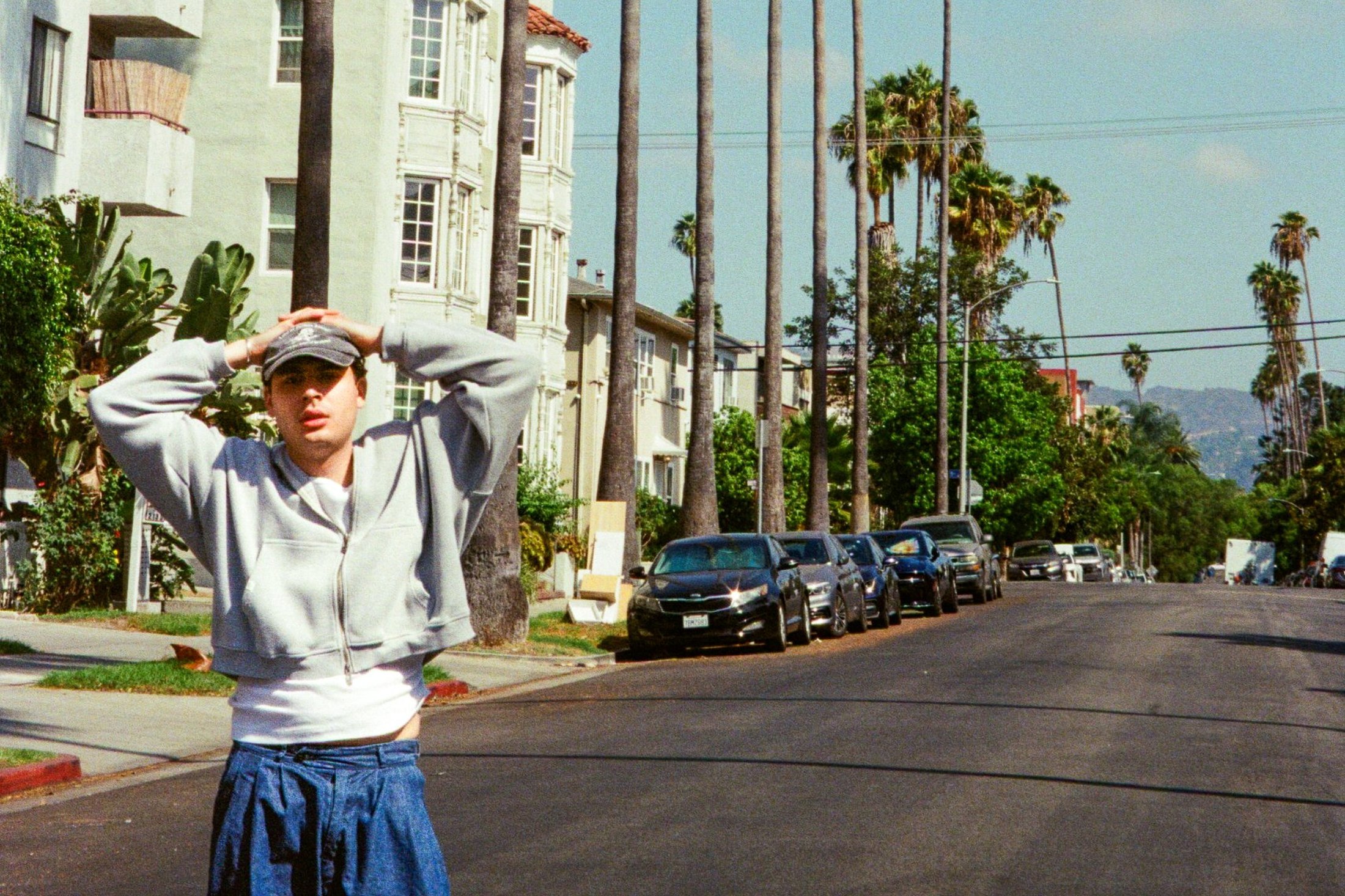 bana standing in the street in la, hands on his head